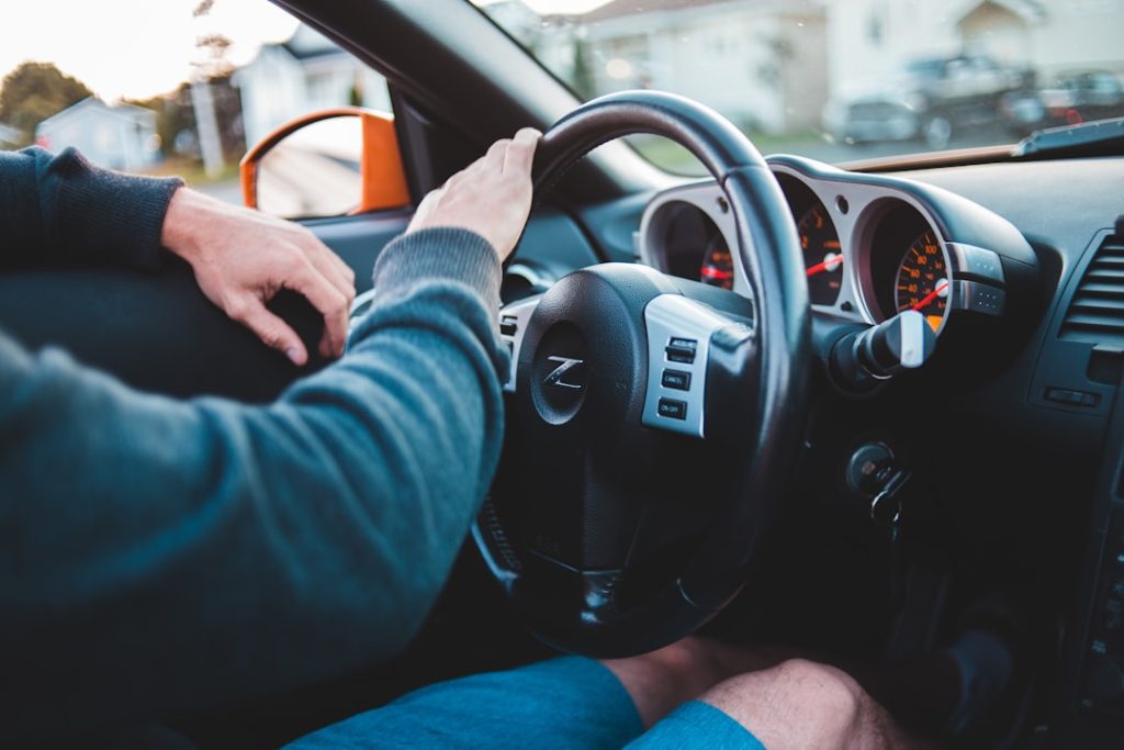 person-in-blue-long-sleeve-shirt-driving-car-vas8dmcjpx8